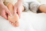 Male masseur massaging a woman's foot