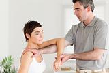 Chiropractor stretching a woman's arm