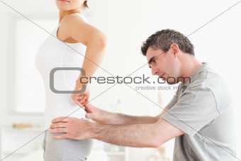 CHiropractor examining a woman's back