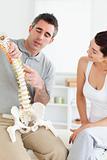 Chiropractor explaining the spine to a woman