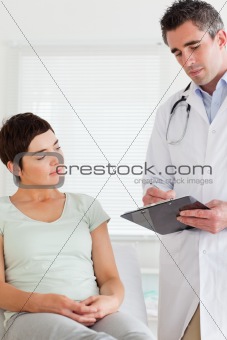 Male Doctor and female patient looking at a chart