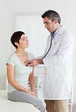 Doctor examining a brunette woman 