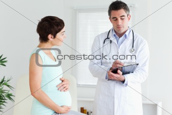Pregnant woman talking to her doctor