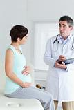 Sitting Pregnant woman talking to her doctor