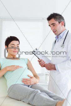 Charming Pregnant woman touching her belly