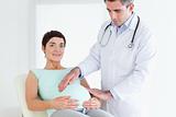 Male Doctor ausculating a pregnant woman's tummy