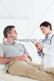Female doctor talking to a male patient