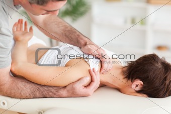 Gorgeous brunette woman getting a shoulder-massage