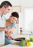 Gorgeous Woman looking into a pan her husband is holding