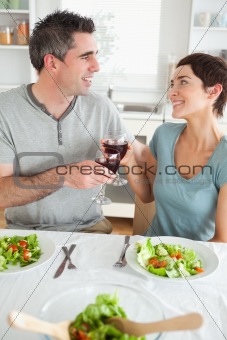 Close up of a Happy couple toasting with redwine