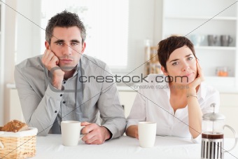 Tired couple drinking coffee