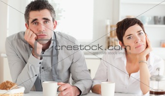 Worn out couple drinking coffee