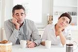 Unhappy couple drinking coffee