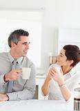 Smiling couple drinking coffee