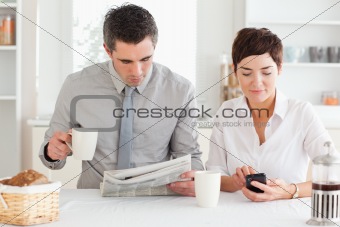 Cute couple preparing for work at breakfast