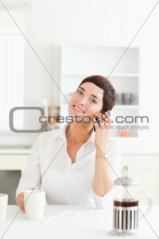 Cute woman on phone in the morning
