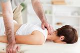 Masseur massaging woman's neck