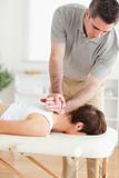 Masseur massaging a female customer's neck