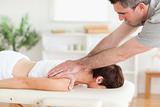 A masseur massaging customer's neck