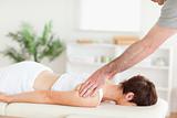 Masseur massaging woman's back