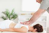 Masseur massaging female customer's back