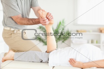 Masseur massaging a customer's foot