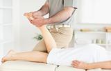 Masseur massaging a woman's foot