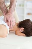 Female customer's neck massaged by masseur