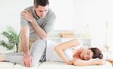 Masseur massaging woman's hip