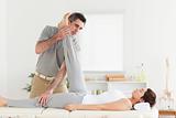 Chiropractor exercising with a woman