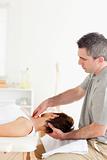 Chiropractor massaging a woman's neck