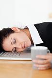 Sleeping businesswoman with her head on laptop