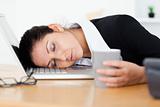Exhausted businesswoman sleeping at workplace