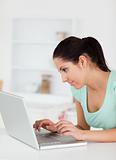 Cute young woman focused on laptop