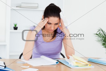 Stressed young woman accounting