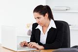 Young businesswoman focused on laptop screen