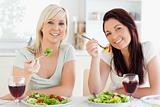 Cheerful young Women eating salad