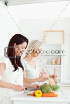 Smiling young Women preparing dinner