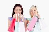 Smiling young women with shopping bags