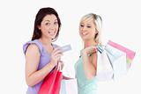 Charming women with shopping bags and a card