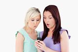 Shocked young women with a cellphone