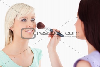 Cute Women applying make-up
