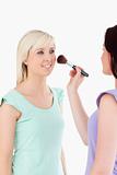 Charming Women applying make-up