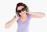 Red-haired Woman with headphones and sunglasses