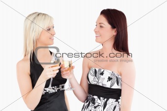Beautiful women in beautiful dresses toasting with champaign