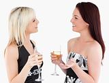 Gorgeous well-dressed women drinking champaign