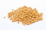 Yellow mustard seeds isolated on white background