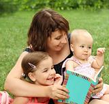 Mother and children reading a book 