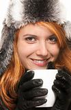 smiling young redhead woman in winter dress holding coffee cup 