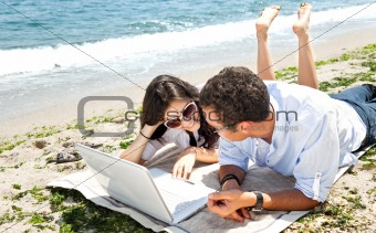 Couple laptop beach